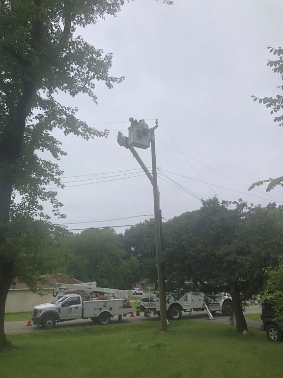 Utility contractors work Friday, Aug. 25, 2023, to repair power lines in Southfield, Mich., north of Detroit. Severe storms powered by winds of up to 75 mph (121 kph) in Michigan downed trees, tore roofs off buildings and killed several people while leaving hundreds of thousands of customers without power, officials said. The National Weather Service said Friday some of the damage may have been caused by two tornadoes. (AP Photo/Corey R. Williams)
