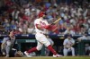 Philadelphia Phillies' Kyle Schwarber watches after hitting a home run against St. Louis Cardinals pitcher Andrew Suarez during the seventh inning of a baseball game, Friday, Aug. 25, 2023, in Philadelphia. (AP Photo/Matt Slocum)