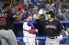 Cleveland Guardians' Ramon Laureano (right) celebrates his two-run home run with Oscar Gonzalez (39) while Toronto Blue Jays catcher Alejandro Kirk (centre) looks on during fourth inning MLB baseball action, in Toronto on Friday, August 25, 2023. THE CANADIAN PRESS/Christopher Katsarov