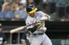 Oakland Athletics' Nick Allen swings into an RBI single off Chicago White Sox starting pitcher Dylan Cease during the fourth inning of a baseball game Friday, Aug. 25, 2023, in Chicago. (AP Photo/Charles Rex Arbogast)