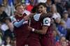 West Ham United's Michail Antonio, centre, celebrates with teammates after scoring his side's third goal, during the English Premier League soccer match between Brighton & Hove and West Ham Untied, at the AMEX, Brighton and Hove, England, Saturday, Aug. 26, 2023. (Gareth Fuller/PA via AP)