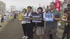 In this image made from video, South Korean lawmakers from left, Kang Eun-mi, Woo Wonshik and Yang Jung-suk, hold placards which reads 