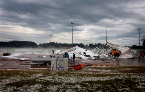 Remains of a marquee destroyed by a storm lie on the outskirts of the town of Kissing, Germany, Saturday Aug. 26, 2023. A storm with large hailstones damaged four-fifths of the buildings in a small town in the southern German state of Bavaria, local authorities said Sunday. The storm swept across the southern part of Bavaria on Saturday. In Kissing, just outside Augsburg, police said 12 people were injured when a beer tent that they were trying to put up was blown over. (Karl-Josef Hildenbrand/dpa via AP)