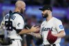 Miami Marlins relief pitcher Tanner Scott, right, and catcher Jacob Stallings congratulate each other after the Marlins beat the Washington Nationals 2-1 in a baseball game, Sunday, Aug. 27, 2023, in Miami. (AP Photo/Wilfredo Lee)