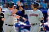 Cleveland Guardians right fielder Ramon Laureano (10) is congratulated by teammate Cleveland Guardians first baseman Kole Calhoun (56) after hitting a two-run home run during eleventh inning MLB American League baseball action in Toronto, Sunday, Aug. 27, 2023. THE CANADIAN PRESS/Frank Gunn