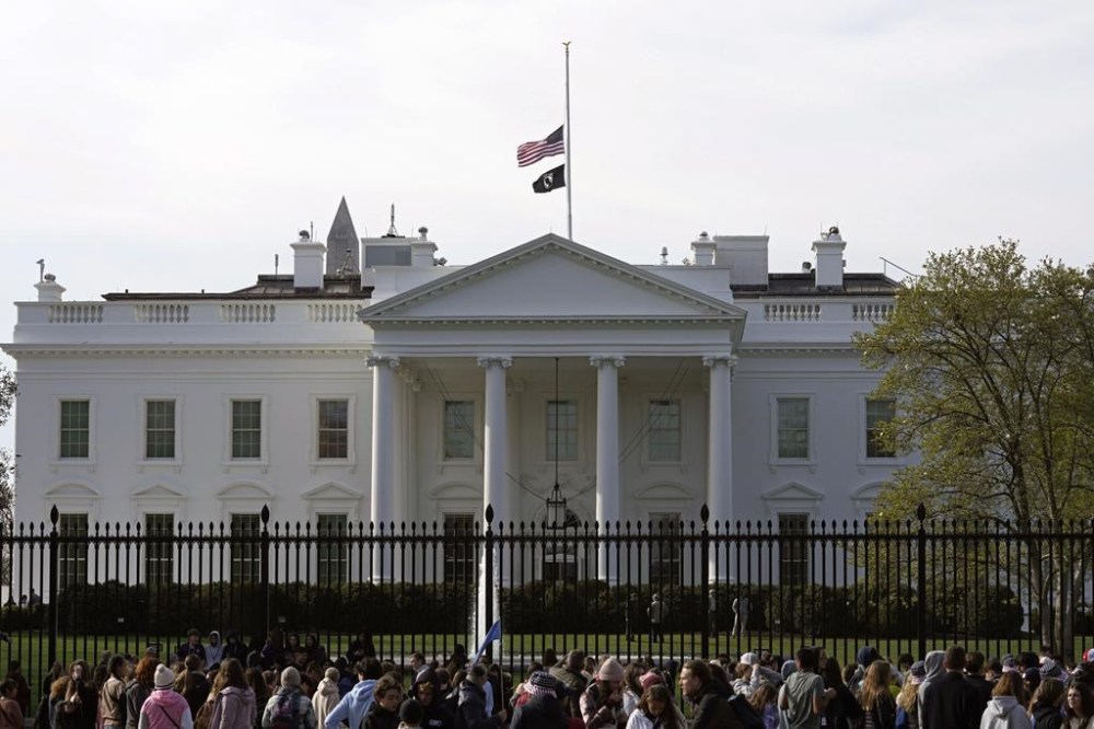 FILE - People walk past the White House in Washington, Tuesday, March 28, 2023. Unflattering portraits of both President Joe Biden and former President Donald Trump emerge clearly in a new poll by The Associated Press-NORC Center for Public Affairs Research, which asked an open-ended question about what comes to mind when people think of them. (AP Photo/Susan Walsh, File)