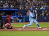 Toronto Blue Jays catcher Danny Jansen (9) hits a home run against the Washington Nationals in third inning MLB interleague baseball action in Toronto on Monday, August 28, 2023. THE CANADIAN PRESS/Andrew Lahodynskyj