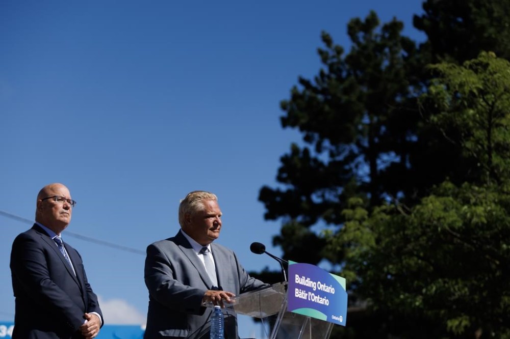 Ontario Premier Doug Ford says the province is looking to return land to the Greenbelt that a developer recently sold. Ontario’s minister of housing Steve Clark listens as Ford speaks during a press conference in Mississauga, Ont., Friday, Aug. 11, 2023. THE CANADIAN PRESS/Cole Burston
