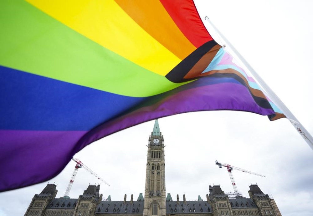 Canada is warning members of the LGBTQ+ community that they may face discrimination if they travel to some places in the United States. A Pride flag flies on Parliament Hill in Ottawa on Thursday, June 8, 2023. THE CANADIAN PRESS/Sean Kilpatrick