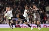 Fulham's Rodrigo Muniz, left, and Tottenham Hotspur's Pierre-Emile Hojbjerg battle for the ball during the Carabao Cup second round soccer match at Craven Cottage, London, Tuesday Aug. 29, 2023. (John Walton/PA via AP)