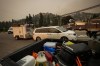 For Canadians facing a short-term loss of income, whether it be from wildfire evacuations or other reasons, financial experts say there are differences in how they should navigate a short-term disruption in pay compared with a longer-term income loss. Evacuees leave with a trailer of belongings after a wildfire evacuation alert was upgraded to an order and they were forced to leave the Wilden neighbourhood near Knox Mountain, in Kelowna, B.C., Friday, Aug. 18, 2023. THE CANADIAN PRESS/Darryl Dyck