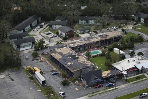 Debris is littered around the damaged Regency Inn Perry in Perry, Fla., following the passage of Hurricane Idalia, Wednesday, Aug. 30, 2023. (AP Photo/Rebecca Blackwell)