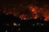 Intact Financial Corp. estimates that its catastrophe losses due to wildfires and other weather total about $570 million for the third quarter so far. The McDougall Creek wildfire burns on the mountainside above houses in West Kelowna, B.C., Friday, Aug. 18, 2023. THE CANADIAN PRESS/Darryl Dyck