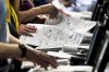 FILE - Election workers perform a recount of ballots from the recent Pennsylvania primary election at the Allegheny County Election Division warehouse in Pittsburgh on June 1, 2022. Prosecutors are trying to stop the menacing of election workers as violent and graphic threats are deluging workers even in normally quiet periods between elections. (AP Photo/Gene J. Puskar, File)