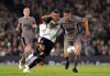 Fulham's Rodrigo Muniz, left, and Tottenham Hotspur's Micky van de Ven battle for the ball during the Carabao Cup second round soccer match at Craven Cottage, London, Tuesday Aug. 29, 2023. (John Walton/PA via AP)