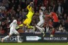West Ham's goalkeeper Alphonse Areola catches the ball as Luton Town's Mads Andersen, right puts pressure on West Ham's Nayef Aguerd during the English Premier League soccer match between Luton Town against West Ham United, in Luton, England, Friday, Sept. 1, 2023. (AP Photo/Frank Augstein)