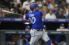 Toronto Blue Jays pinch-hitter Alejandro Kirk watches his three-run double off Colorado Rockies relief pitcher Brent Suter during the seventh inning of a baseball game Friday, Sept. 1, 2023, in Denver. (AP Photo/David Zalubowski)