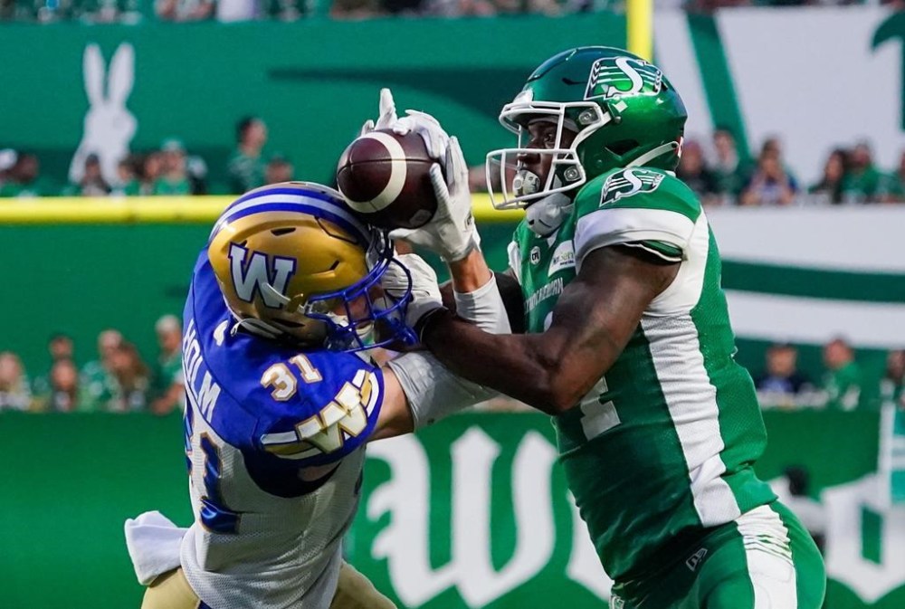 With the Winnipeg Blue Bombers on the verge of clinching a CFL playoff spot, Saskatchewan head coach Craig Dickenson understands Sunday’s Labour Day Classic will be a tough challenge for his Saskatchewan Roughriders. Winnipeg Blue Bombers defensive back Evan Holm (31) and Saskatchewan Roughriders wide receiver Tevin Jones (14) battle for the ball during the second half of CFL football action in Regina, Friday, June 16, 2023. THE CANADIAN PRESS/Heywood Yu