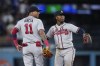 Atlanta Braves' Orlando Arcia, left, and Ozzie Albies celebrate the team's 4-2 win over the Los Angeles Dodgers in 10 innings in a baseball game Saturday, Sept. 2, 2023, in Los Angeles. (AP Photo/Jae C. Hong)