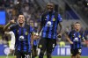 Inter Milan's Hakan Calhanoglu, left, celebrates with Inter Milan's Marcus Thuram after scoring his sides third goal during the Serie A soccer match between Inter Milan and Fiorentina at the San Siro Stadium, in Milan, Italy, Sunday, Sept. 3, 2023. (AP Photo/Antonio Calanni)