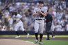 San Francisco Giants starting pitcher Kyle Harrison, right, waits to face the next batter as San Diego Padres' Xander Bogaerts, left, rounds the bases after hitting a home run during the second inning of a baseball game Saturday, Sept. 2, 2023, in San Diego. (AP Photo/Gregory Bull)