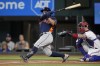 Houston Astros' Jose Altuve, left, follows through on a solo home run as Texas Rangers' Jonah Heim looks on in the first inning of a baseball game, Tuesday, Sept. 5, 2023, in Arlington, Texas. (AP Photo/Tony Gutierrez)