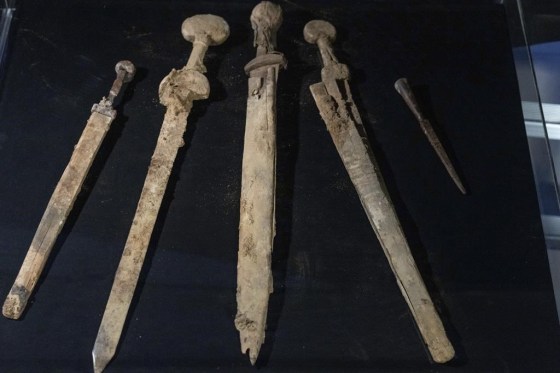 Four Roman-era swords and a javelin head found during a recent excavation in a cave near the Dead Sea. (Ohad Zwigenberg / The Associated Press)