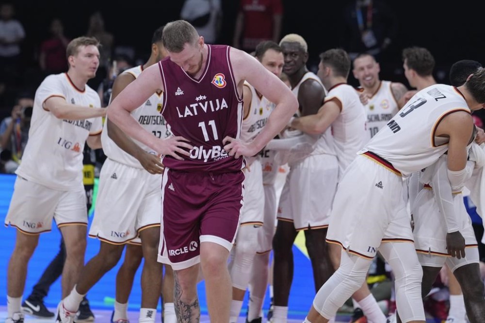 Latvia forward Rolands Šmits (11) reacts following his team's two point loss to Germany in their Basketball World Cup quarterfinal in Manila, Philippines, Wednesday, Sept. 6, 2023. (AP Photo/Michael Conroy)