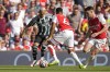 Manchester United's Antony, left, is challenged by Arsenal's Gabriel, center, during the English Premier League soccer match between Arsenal and Manchester United at Emirates stadium in London, Sunday, Sept. 3, 2023. (AP Photo/Kirsty Wigglesworth)