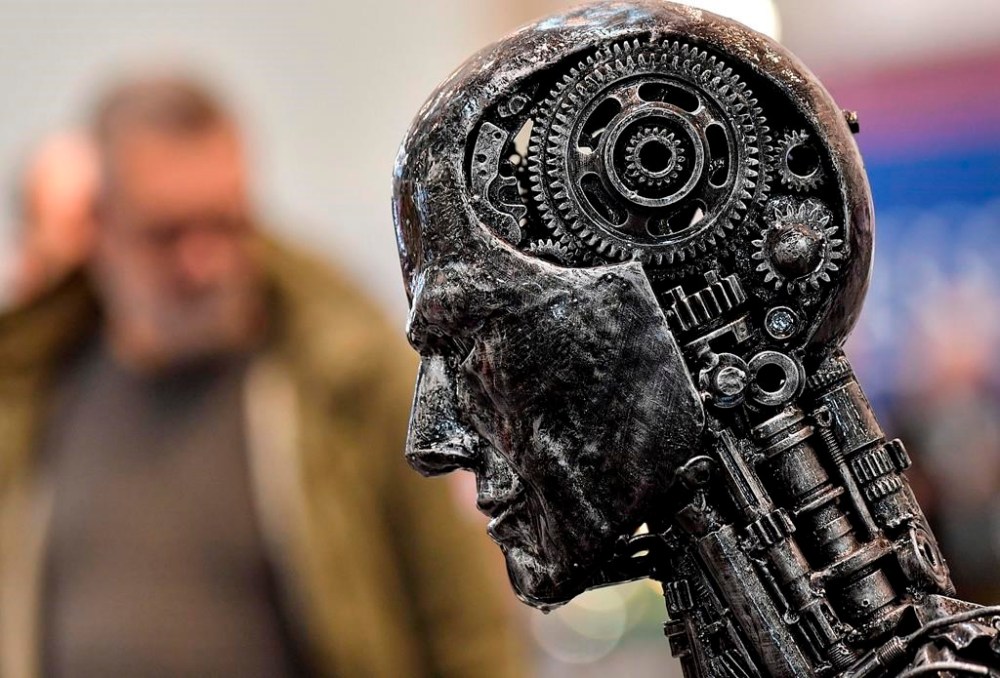 A global group of 25 organizations including news and publishing companies is calling on developers, operators and deployers of artificial intelligence systems to respect intellectual property rights. A metal head made of motor parts symbolizes artificial intelligence, or AI, at the Essen Motor Show for tuning and motorsports in Essen, Germany on Nov. 29, 2019, file photo. THE CANADIAN PRESS/AP/Martin Meissner