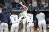 Tampa Bay Rays' Brandon Lowe, center, is doused with liquid after his three-run walk off home run off Boston Red Sox relief pitcher Kenley Jansen during the 11th inning of a baseball game Tuesday, Sept. 5, 2023, in St. Petersburg, Fla. (AP Photo/Chris O'Meara)