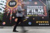 The Toronto International Film Festival is rolling out the red carpets for what organizers pledge will be a return to form in the shadow of the actors strike. A person walks past the Toronto International Film Festival (TIFF) Bell Lightbox in the Entertainment District of Toronto, Thursday, Aug. 17, 2023. THE CANADIAN PRESS/Spencer Colby