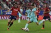 Barcelona's Robert Lewandowski, center, attempts a shot on goal past Osasuna's Alejandro Catena during Spanish La Liga soccer match between Osasuna and Barcelona at El Sadar stadium in Pamplona, Spain, Sunday, Sept. 3, 2023. (AP Photo/Alvaro Barrientos)