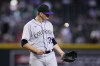 Colorado Rockies starting pitcher Chris Flexen flips a new baseball in the air after giving up a three-run home run to Arizona Diamondbacks' Alek Thomas during the third inning of a baseball game Wednesday, Sept. 6, 2023, in Phoenix. (AP Photo/Ross D. Franklin)