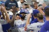 Los Angeles Dodgers' Jason Heyward is congratulated by teammates after he hit a home run during the fourth inning of a baseball game against the Miami Marlins, Wednesday, Sept. 6, 2023, in Miami. (AP Photo/Wilfredo Lee)