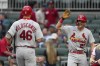 St. Louis Cardinals' Lars Nootbaar (21), right, reaacts as he waits for Paul Goldschmidt (46) to cross homeplate after Goldschmidt's two-run home run in the first inning of a baseball game against the Atlanta Braves Wednesday, Sept. 6, 2023, in Atlanta. (AP Photo/John Bazemore)