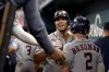 Houston Astros' Jose Abreu, center, celebrates with Alex Bregman (2) and the rest of the team in the dugout after Abreu hit a three-run home run in the ninth inning of a baseball game against the Texas Rangers, Wednesday, Sept. 6, 2023, in Arlington, Texas. (AP Photo/Tony Gutierrez)