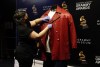Collections assistant Cyrene Cruz primps a red leather jacket that was worn by the late rapper The Notorious B.I.G. in preparation for the exhibit 