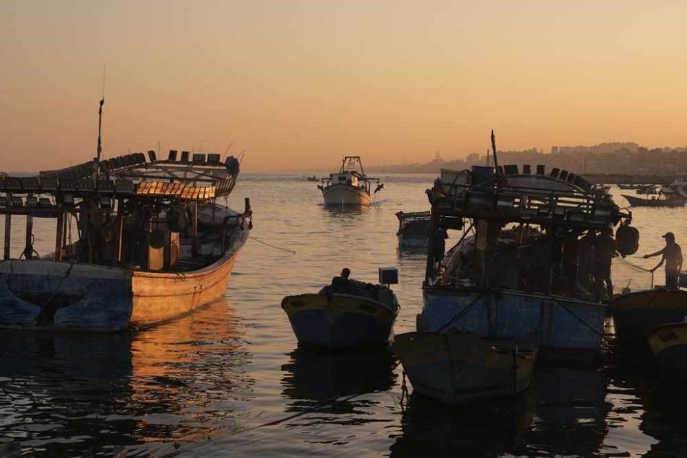 Palestinian fishing boats return after a nighttime fishing trip to the seaport in Gaza City, Thursday, Sept. 7, 2023. After allegedly uncovering explosives hidden in clothing shipped from Gaza to the West Bank, the Israeli government opted for a punitive response this week, clamping down on all cargo shipments out of Gaza and choking off the territory's already ailing economy. (AP Photo/Adel Hana)
