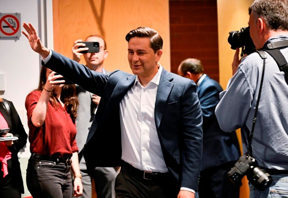 Conservative Leader Pierre Poilievre waves as he enters a caucus meeting, prior to the Conservative convention, in Quebec City, Thursday, Sept. 7, 2023. THE CANADIAN PRESS/Jacques Boissinot