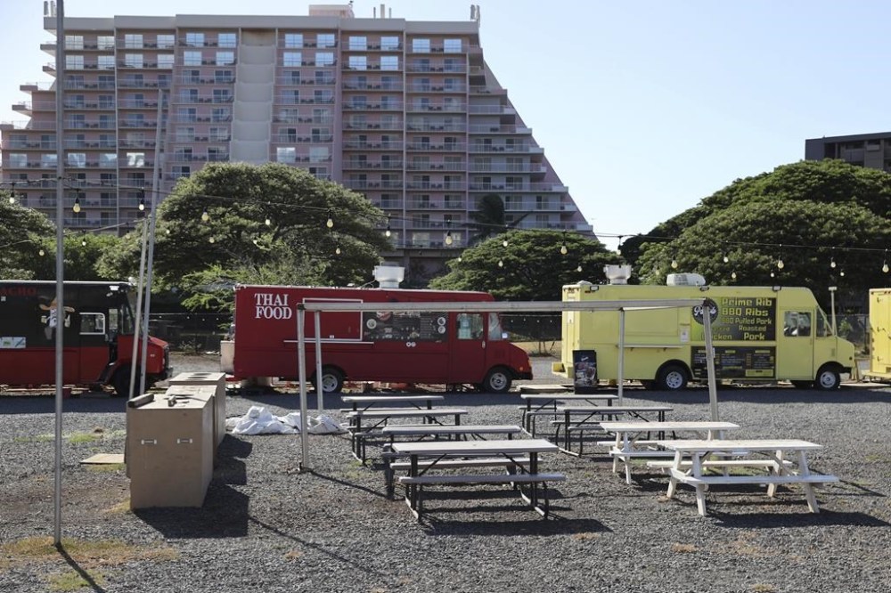 Food trucks which mostly cater to tourists from hotels in the area remain closed several weeks after wildfires devastated the town of Lahaina, Friday, Sept. 1, 2023, in Kahana, Hawaii. So few tourists are coming to the Hawaiian island of Maui after last month's wildfires that restaurants and tour companies are laying off workers and unemployment is surging. State tourism officials initially urged travelers to stay away but now want them to come back so long as they refrain from going to the burn zone and surrounding area. (AP Photo/Marco Garcia)
