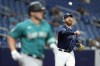 Tampa Bay Rays relief pitcher Zack Littell, right, throws out Seattle Mariners' Ty France at first base during the seventh inning of a baseball game Thursday, Sept. 7, 2023, in St. Petersburg, Fla. (AP Photo/Chris O'Meara)