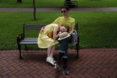 FILE - A woman takes a nap on the lap of her husband on a bench at Saint Sophia Cathedral in Kyiv, Ukraine, Sunday, July 30, 2023. Life in the capital of a war-torn country seems normal on the surface. In the mornings, people rush to their work holding cups of coffee. Streets are filled with cars, and in the evenings restaurants are packed. But the details tell another story. (AP Photo/Jae C. Hong, File)