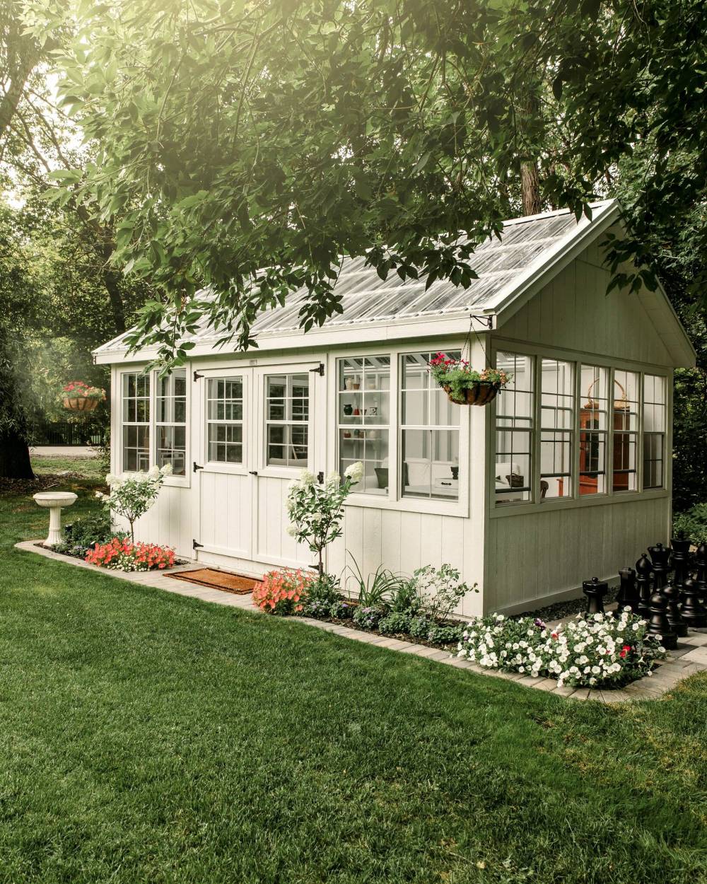 In spring, this charming greenhouse is filled with flower and vegetable seedlings.