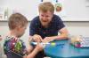 Mike Deal / Winnipeg Free Press 
                                St. George School kindergarten teacher Kenny Benson spends some one-on-one time with Dima as the children arrive for school.
