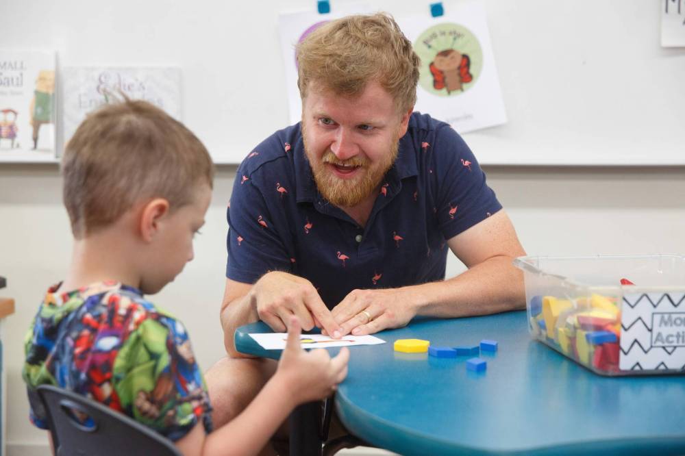 Mike Deal / Winnipeg Free Press
St. George School kindergarten teacher Kenny Benson spends some one-on-one time with Dima as the children arrive for school.