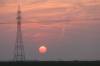 Monday evening’s setting sun, as seen from a wheat field west of Brandon, is made red by the ongoing smoke in the atmosphere from burning wildfires. Environment Canada predicts that the air quality health index will be low risk for all day Wednesday for Brandon. (Matt Goerzen/The Brandon Sun)