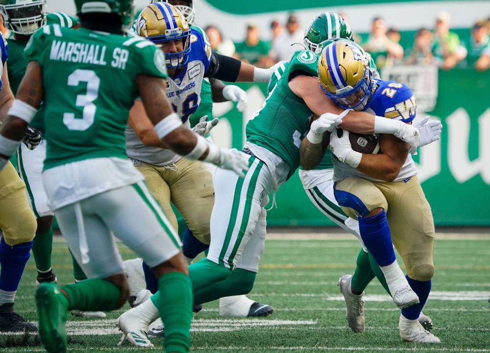 Winnipeg Blue Bombers running back Brady Oliveira (20) runs the football against Saskatchewan Roughriders during the first half of CFL Labour Day Classic football action in Regina, Sunday, Sept. 3, 2023. (Heywood Yu / The Canadian Press)