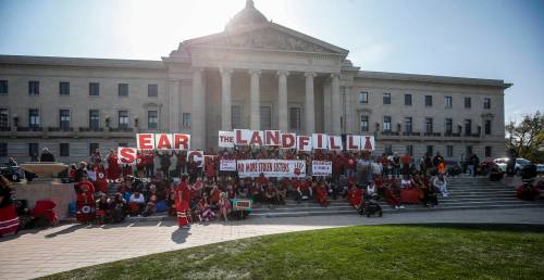 JOHN WOODS / THE CANADIAN PRESS
                                Supporters and family gather at a rally to search Winnipeg landfill for three missing women at the Manitoba Legislature in Winnipeg on Monday.