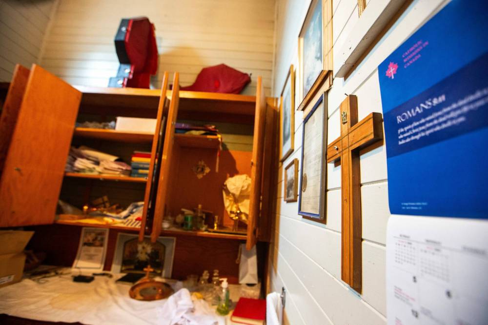 MIKAELA MACKENZIE / WINNIPEG FREE PRESS
                                A cross where Jesus was ripped off hangs on the wall. Above the cupboard, a case remains empty which previously held the missing monstrance.